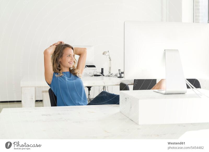 Casual businesswoman sitting in office modern contemporary smiling smile businesswomen business woman business women entrepreneur entrepreneurs Seated offices