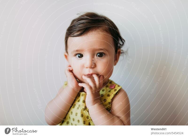 Portrait of baby girl with hand on mouth on white background portrait portraits infants nurselings babies people persons human being humans human beings face