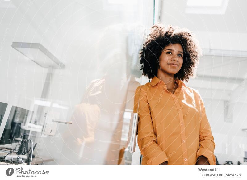 Portrait of young woman in office females women smiling smile standing portrait portraits Adults grown-ups grownups adult people persons human being humans