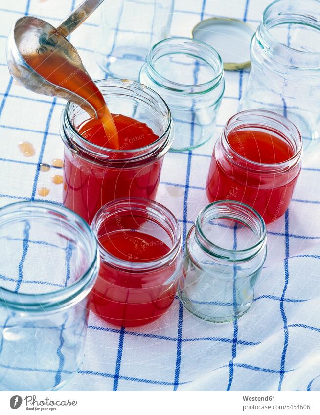 Pouring plum jam into jars homemade home made home-made Soup Ladle checked Checked Pattern chequered plaid checkered Jam Jelly Marmalade gellant gelling agent