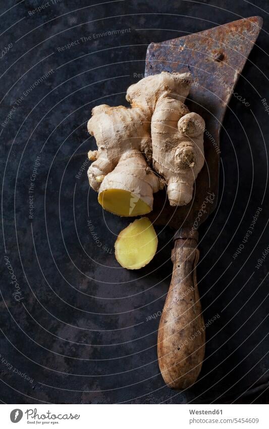 Sliced ginger root on an old knife dark background overhead view from above top view Overhead Overhead Shot View From Above nobody healthy eating nutrition