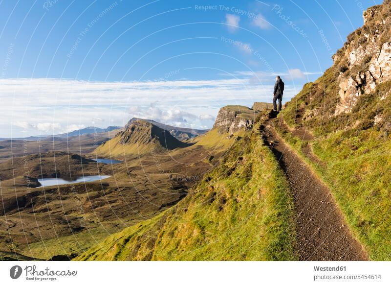 UK, Scotland, Inner Hebrides, Isle of Skye, Trotternish, hiking trail at Quiraing, Loch Cleat, hiker looking at view lake lakes rural scene Non Urban Scene