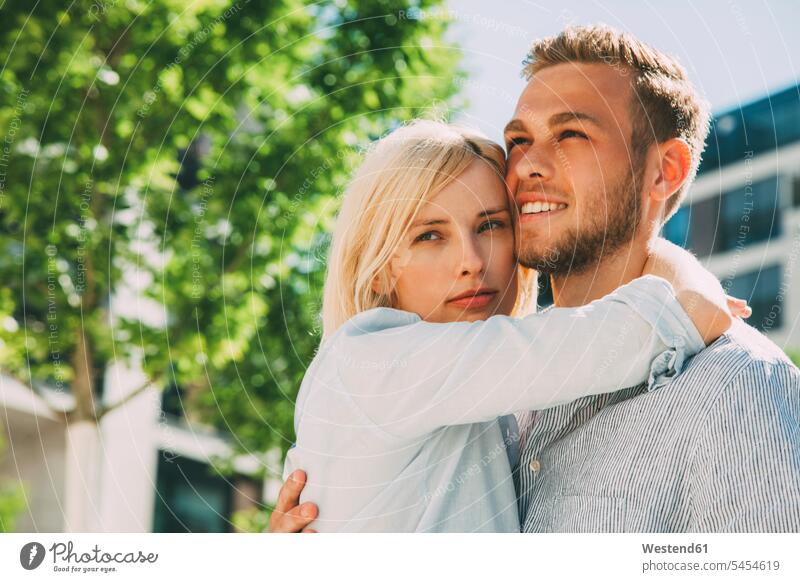 Portrait of happy couple twosomes partnership couples embracing embrace Embracement hug hugging people persons human being humans human beings smiling smile