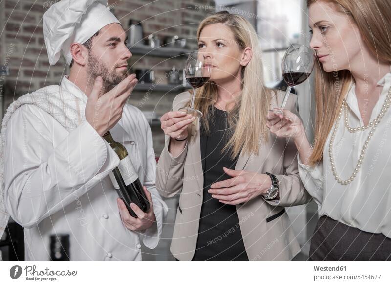 Chef with two women in kitchen tasting wine chef cook cooks Chefs Red Wine Red Wines cooking course cooking class cooking lesson Alcohol alcoholic beverage