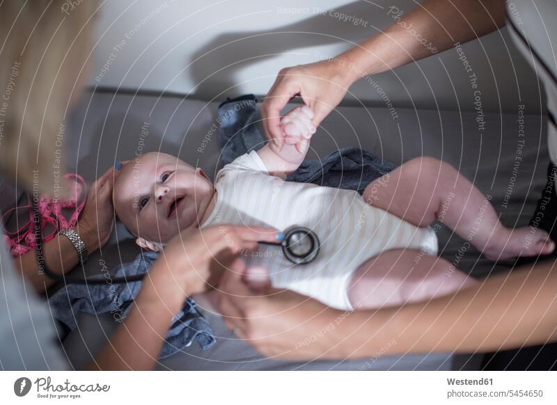 Mother and baby at a pedeatric examination babies infants Auscultation auscultate auscultating stethoscope pediatrician paediatricians people persons