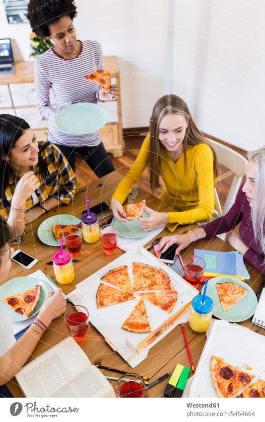 Group of young women at home studying and having pizza Pizza Pizzas student female students woman females Food foods food and drink Nutrition Alimentation