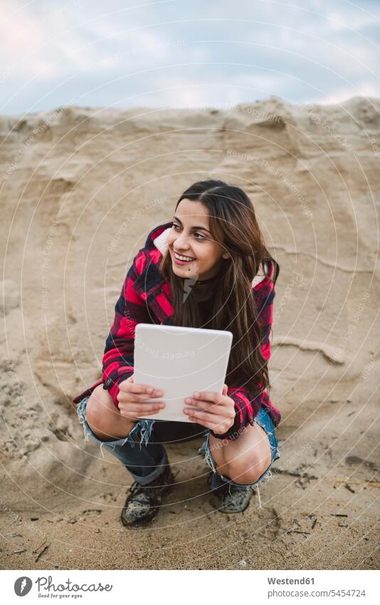 Young woman with tablet crouching on the beach digitizer Tablet Computer Tablet PC Tablet Computers iPad Digital Tablet digital tablets females women computer