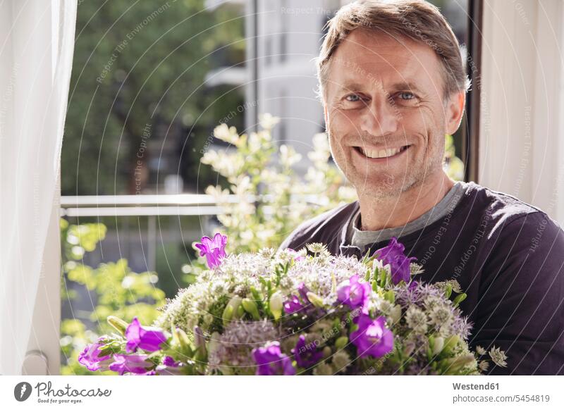 Portrait of smiling man with bunch of flowers men males Bunch of Flowers Bouquet Flower Bouquet Bouquet of Flowers Flower Bouquets Bunches of Flowers portrait