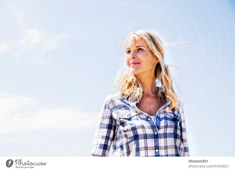 Blond woman wearing checked shirt outdoors portrait portraits smiling smile females women Adults grown-ups grownups adult people persons human being humans