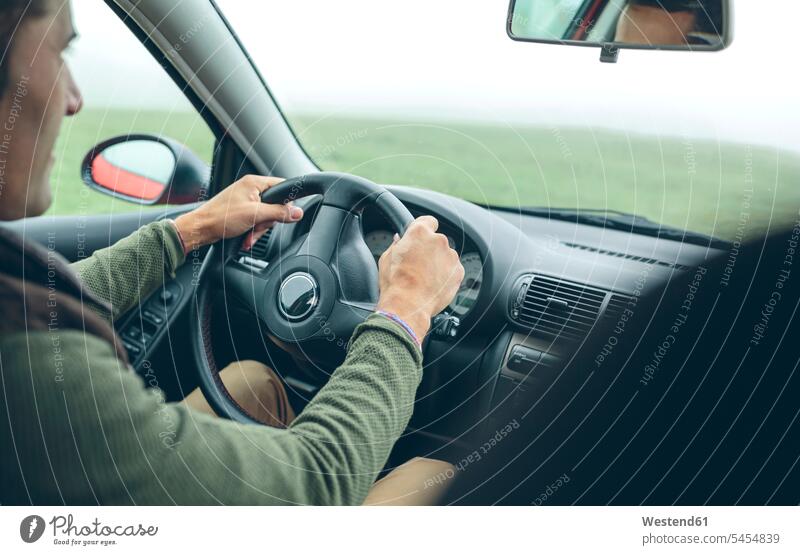 Man driving car man men males drive automobile Auto cars motorcars Automobiles Adults grown-ups grownups adult people persons human being humans human beings