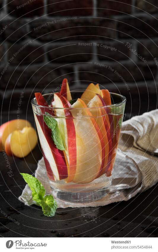 Glass of detox water with sliced red apple and mint Drinking Glasses healthy Slice Slices fruit garnished ready to eat ready-to-eat Pepper mint peppermint