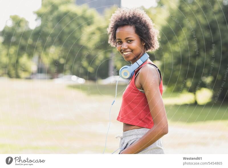 Portrait of smiling sporty young woman in park smile exercising exercise training practising females women Jogging parks Adults grown-ups grownups adult people