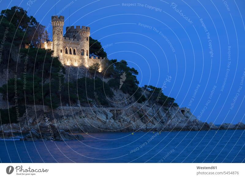 Spain, Catalonia, Lloret de Mar, Costa Brava coast at night, castle on cliff top illuminated lit lighted Illuminating illumination lighting nature natural world