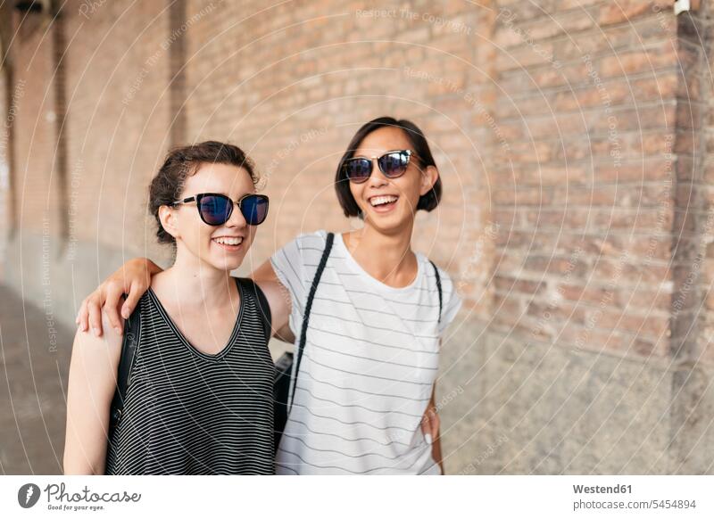 Portrait of two best friends with sunglasses having fun female friends bff mate friendship portrait portraits sun glasses Pair Of Sunglasses laughing Laughter