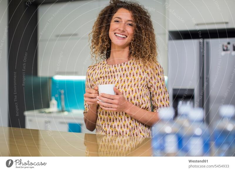 Portrait of smiling woman in office kitchen holding cup break portrait portraits Coffee smile Drink beverages Drinks Beverage food and drink Nutrition