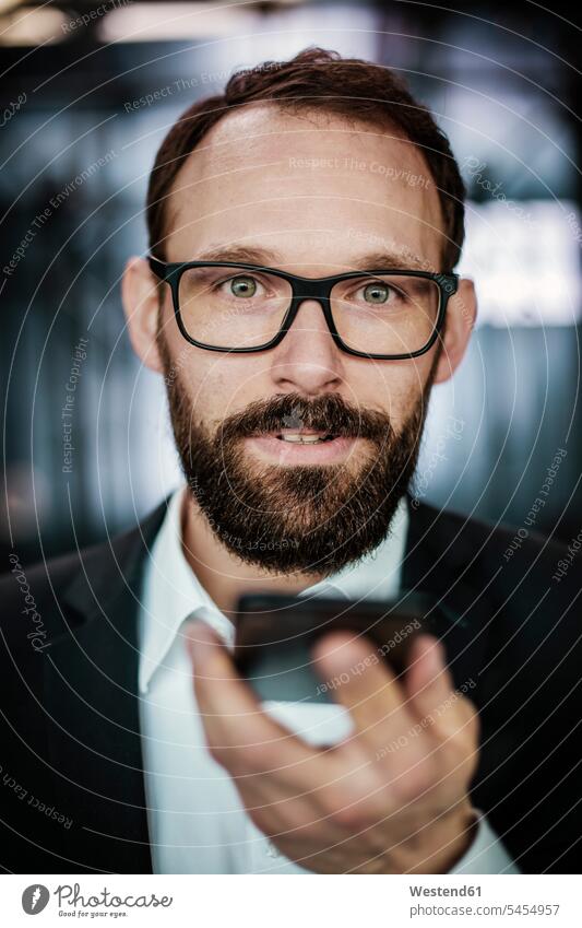 Portrait of an ambitious businessman, using smartphone portrait portraits on the phone call telephoning On The Telephone calling Businessman Business man