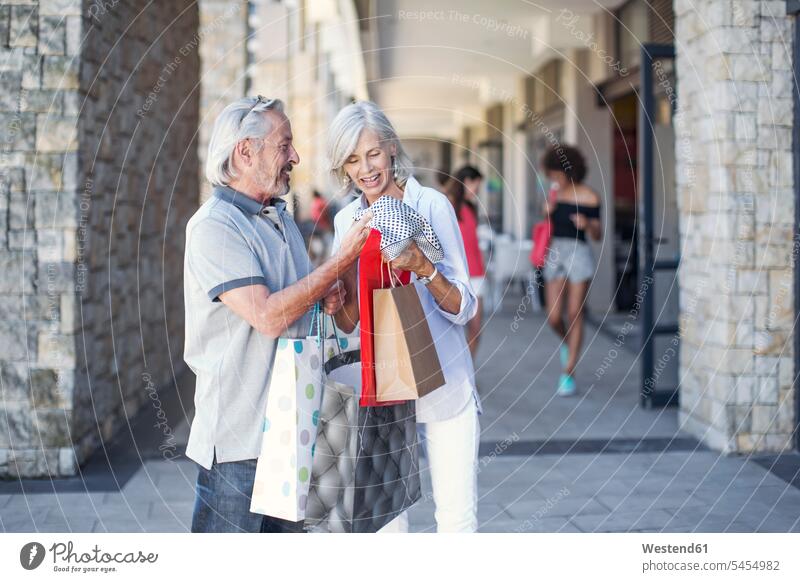 Senior couple taking a city break, going on a shopping spree happiness happy shopping expedition City Break City Trip Urban Tourism on the move on the way