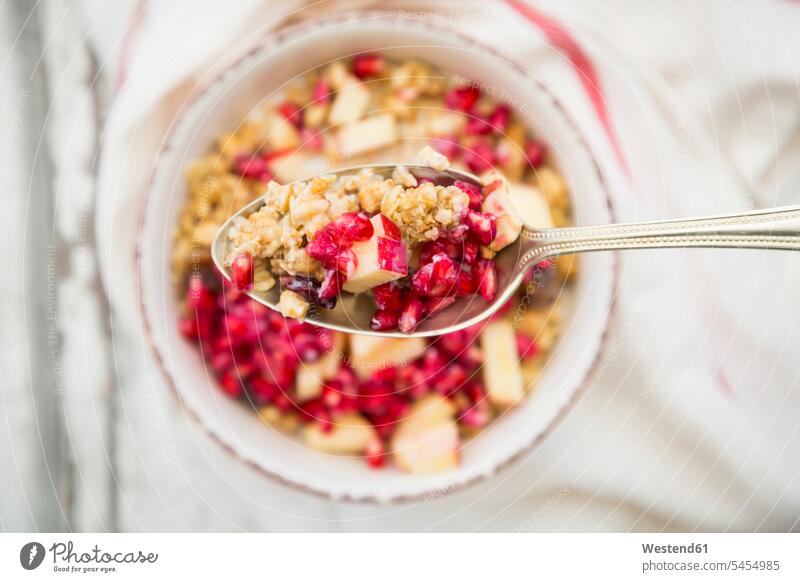Spoon of fruit muesli with dried cranberries, apple and pomegranate seed Spoons kitchen towel cereal bowl muesli bowls cereal bowls red copy space Cranberry