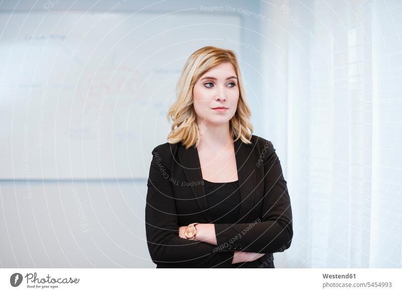 Portrait of serious businesswoman in office offices office room office rooms businesswomen business woman business women earnest Seriousness austere workplace