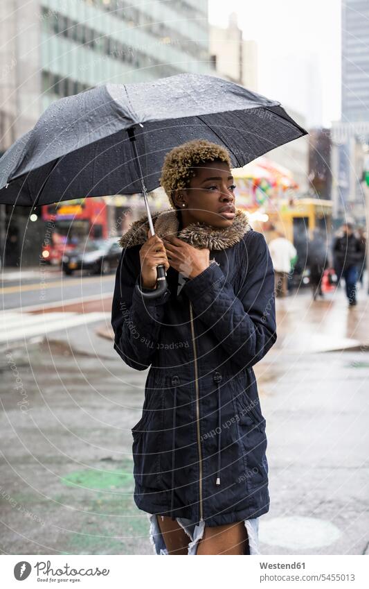 USA, New York City, portrait of young woman with umbrella on rainy day umbrellas portraits Brolly rainy weather raining tore torn beautiful attractive pretty