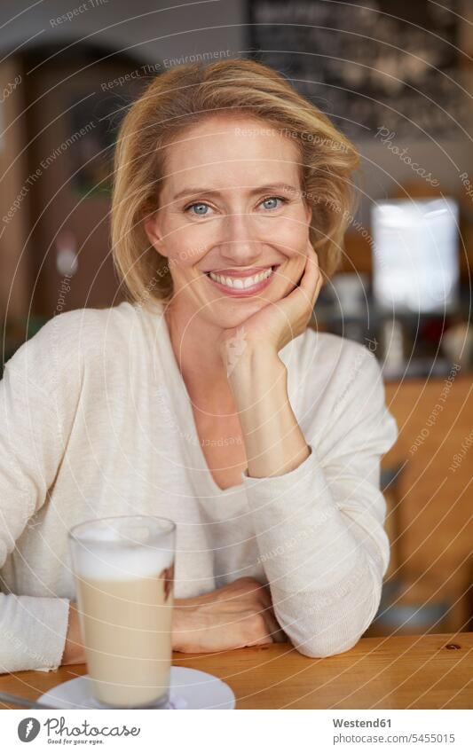Portrait of relaxed woman with Latte Macchiato in a coffee shop portrait portraits females women cafe Adults grown-ups grownups adult people persons human being