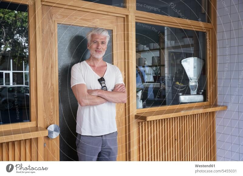 Mature man standing in front of his restaurant men males arms crossed Arms Folded Folded Arms Crossed Arms Crossing Arms Arms Clasped door doors restaurants