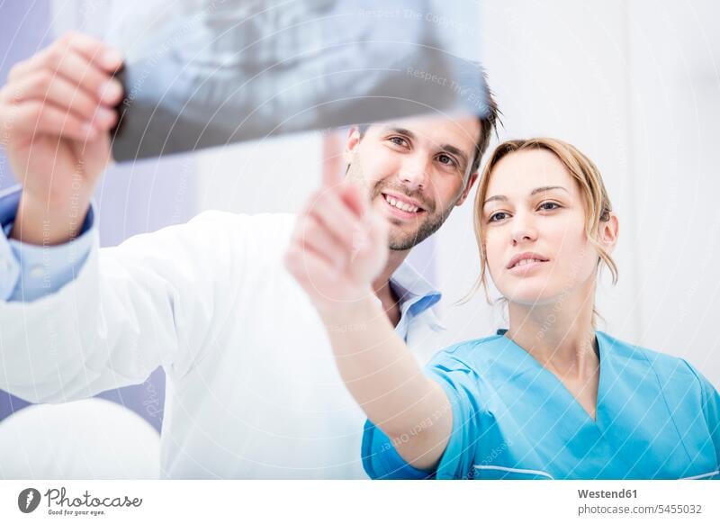 Two doctors discussing dental x-ray image Medical X-Ray Female Doctor physicians Female Doctors discussion dentist dental surgeon colleagues x-raying