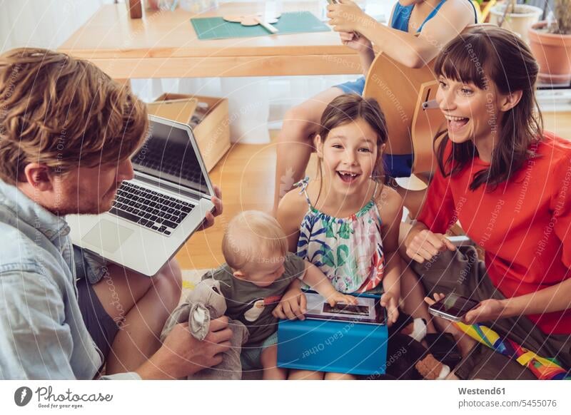 Happy playful family using digital devices in children's room families playing laptop Laptop Computers laptops notebook people persons human being humans