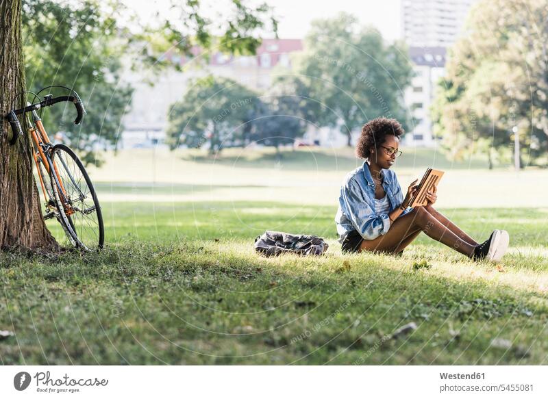 Young woman resting in park using tablet digitizer Tablet Computer Tablet PC Tablet Computers iPad Digital Tablet digital tablets females women parks sitting