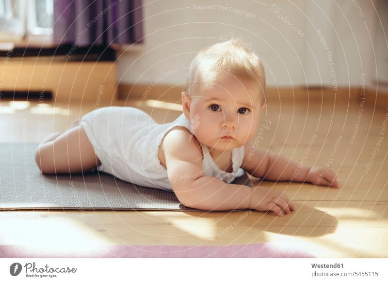 Portait of baby lying on yoga mat infants nurselings babies portrait portraits Yoga Mat laying down lie lying down people persons human being humans