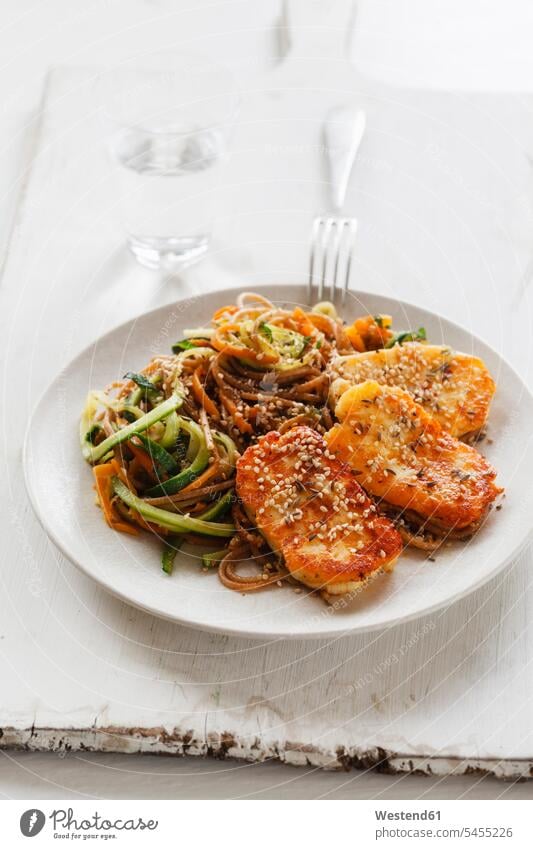 Spelt whole grain spaghetti with zoodles, carrot slices and fried Halloumi Plate dish dishes Plates prepared hearty savoury food lusty sesame garnished