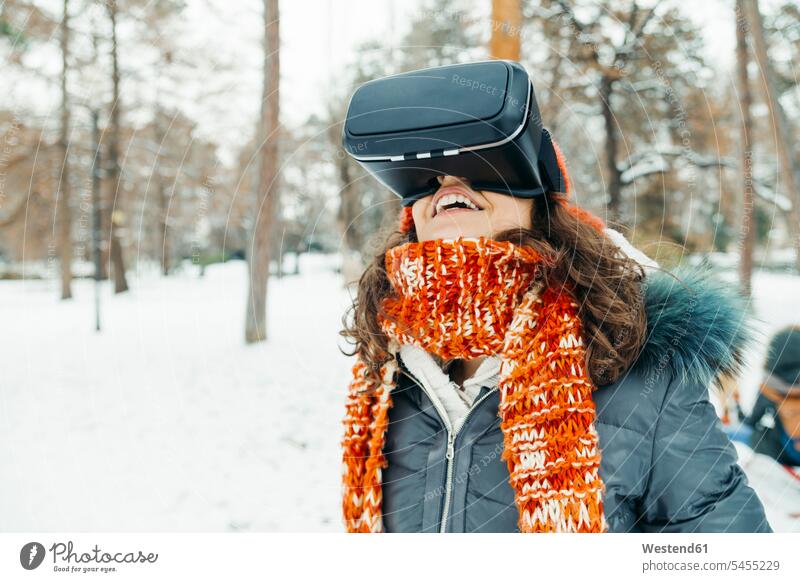 Woman wearing Virtual Reality Glasses in winter landscape woman females women VR glasses Virtual-Reality Glasses virtual reality headset vr headset vr goggles