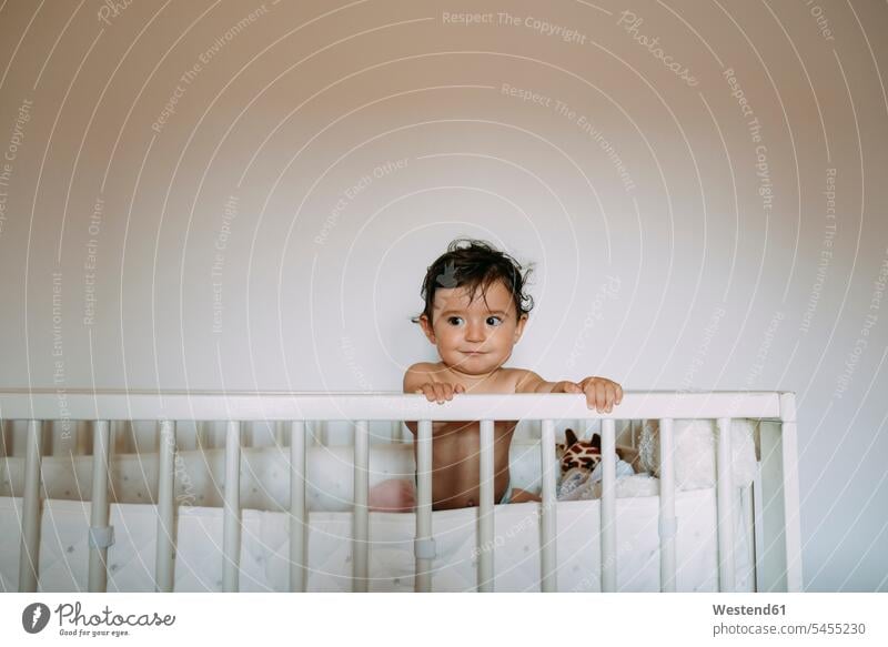 Portrait of baby girl in crib portrait portraits baby cot baby crib Cot children's bed infants nurselings babies beds people persons human being humans