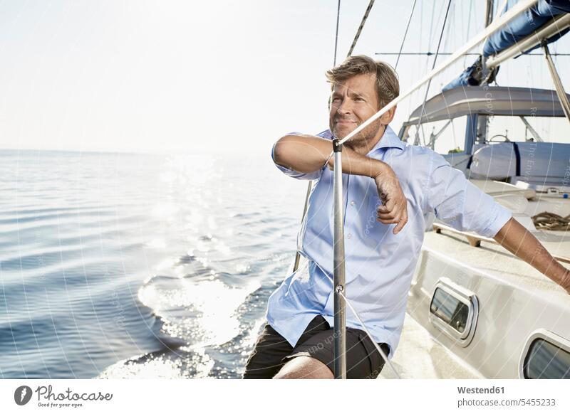 Portrait of smiling mature man on his sailing boat men males boat sports Adults grown-ups grownups adult people persons human being humans human beings Sea