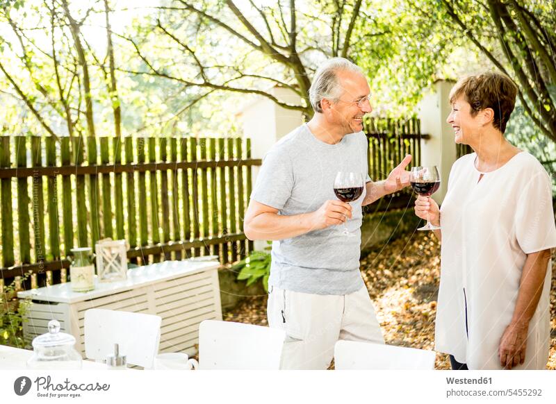 Happy senior couple having glass of red wine outdoors Wine smiling smile twosomes partnership couples Alcohol alcoholic beverage Alcoholic Drink
