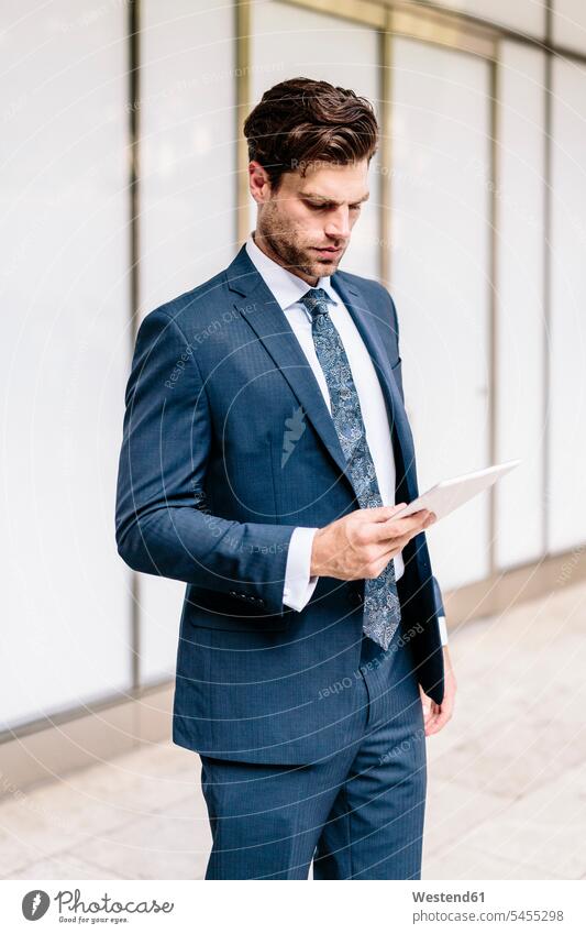 Handsome businessman using digital tablet attractive beautiful pretty good-looking Attractiveness reading digitizer Tablet Computer Tablet PC Tablet Computers