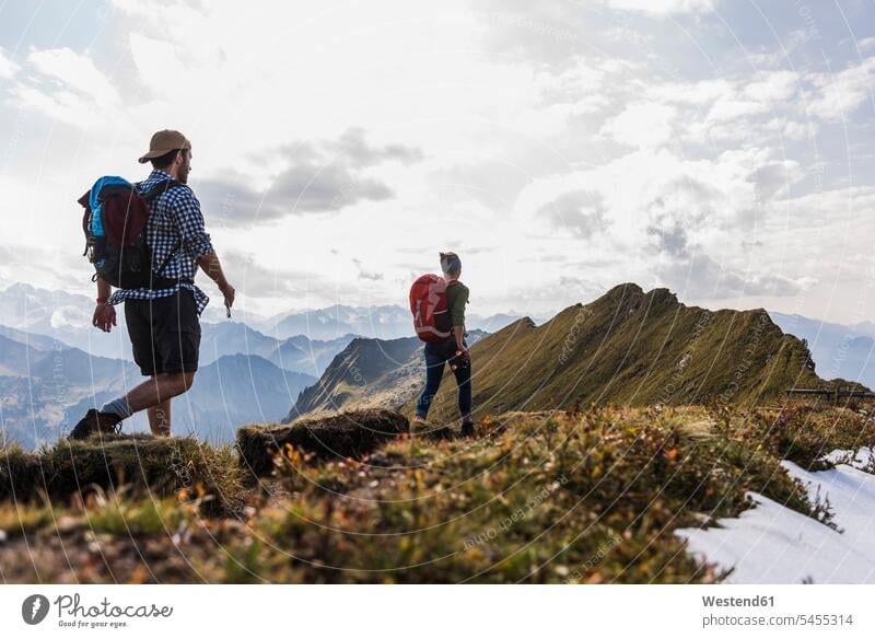 Germany, Bavaria, Oberstdorf, two hikers walking on mountain ridge mountain range mountains mountain ranges going hiking couple twosomes partnership couples