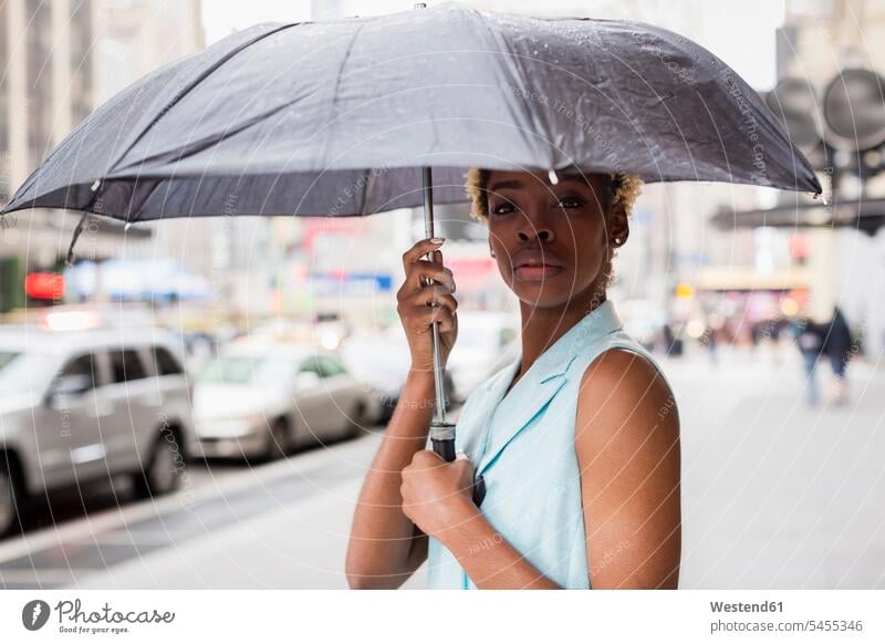 USA, New York, Portrait of young blonde african-american woman with umbrella African-American Ethnicity Afro-American African American Ethnicity