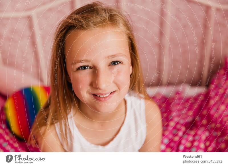 Portrait of smiling little girl in bedroom females girls portrait portraits child children kid kids people persons human being humans human beings beds
