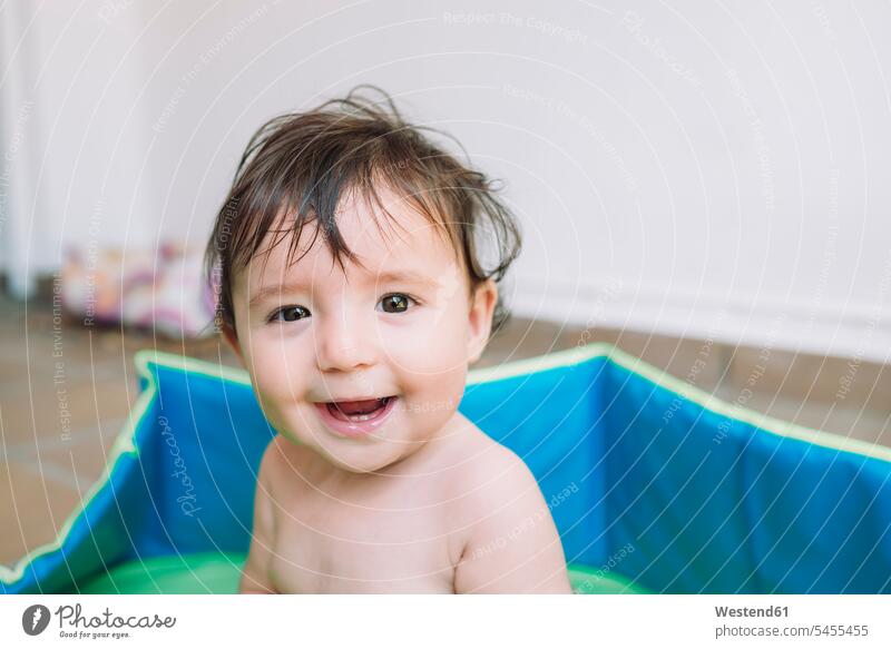 Portrait of smiling baby girl in a pool portrait portraits baby girls female babies infants people persons human being humans human beings honest good