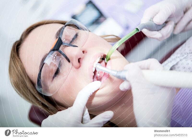 Woman at the dentist receiving root canal treatment patient Medical Treatment treatments woman females women patients healthcare and medicine medical