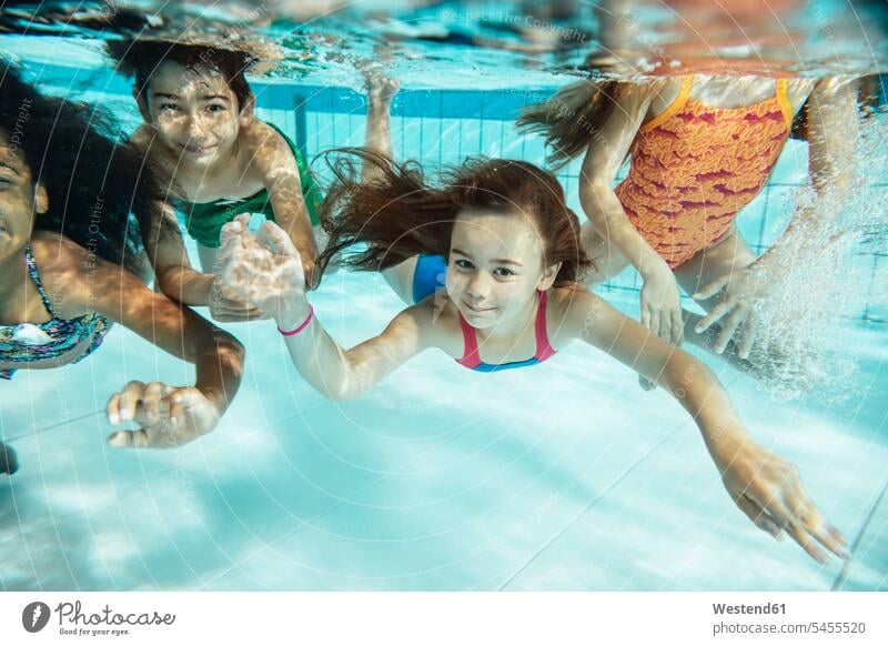 Portrait of happy children swimming under water in swimming pool swimming bath happiness kid kids underwater submerged Under Water underwater shot