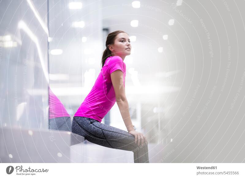 Young woman in pink sportshirt resting after a run young women young woman jogger joggers female jogger exercising exercise training practising females Adults