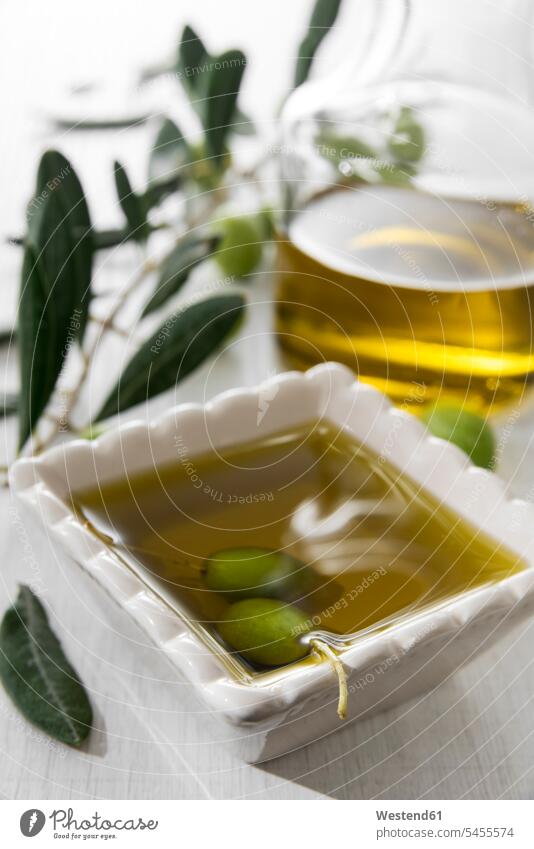 Fresh olive oil in bowl with green olives oils herb-flavoured oil herbal oil green Olive homemade home made home-made Bottle Bottles Bowl Bowls