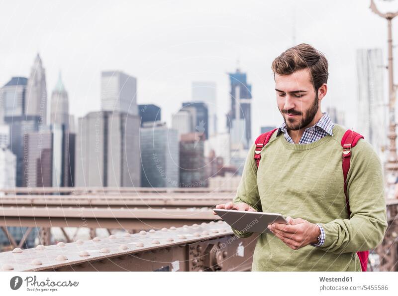 USA, New York City, man on Brooklyn Bridge using tablet digitizer Tablet Computer Tablet PC Tablet Computers iPad Digital Tablet digital tablets New York State