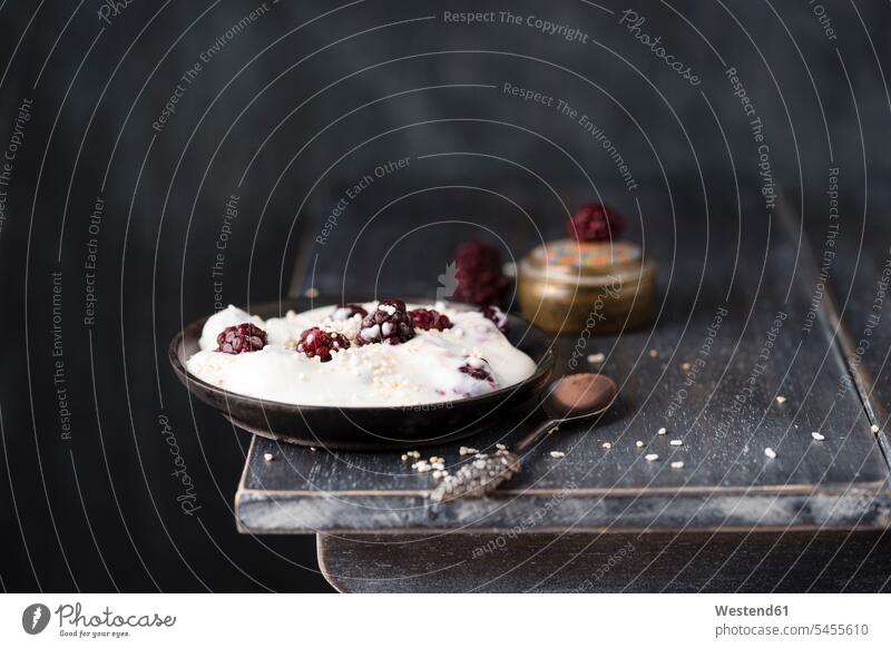 Bowl of natural yoghurt with blackberries and popped amarant Bowls Dessert Afters Desserts dark background popped amaranth puffed amarant puffed amaranth