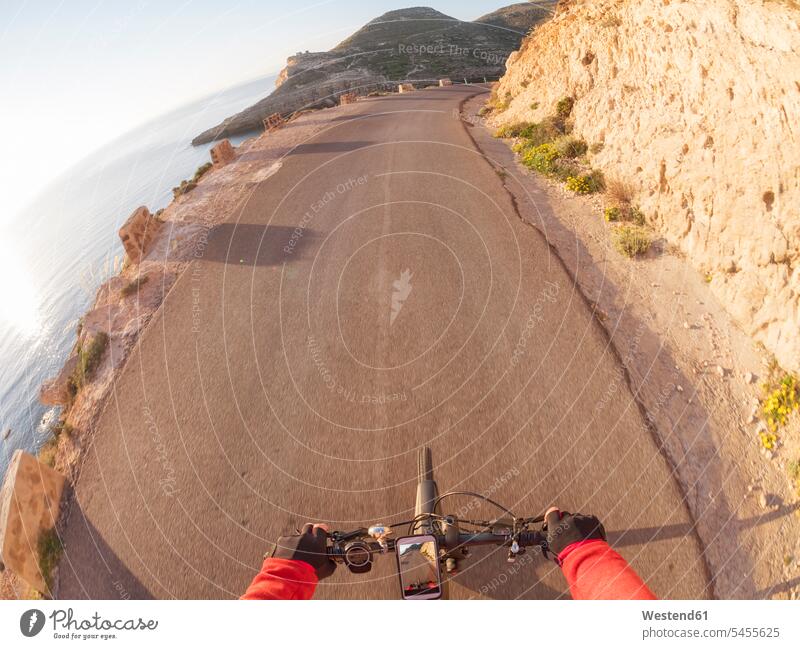 Spain, Andalusia, Cabo de Gata, personal perspective of cyclist on a street Smartphone iPhone Smartphones road streets roads driving drive bicycle bikes