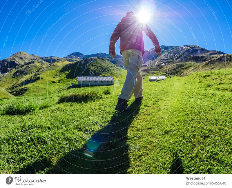 Italy, Lombardy, Sondrio, hiker on alpine meadow on the way to Umbrail Pass Cancano View Vista Look-Out outlook Passo Umbrail Travel sky skies leisure free time