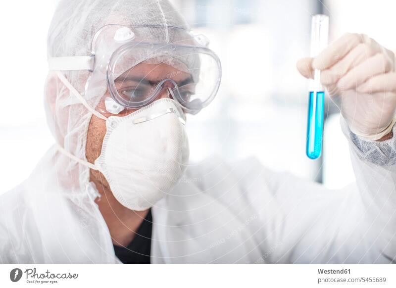 Scientist working in lab holding a test tube At Work scientist laboratory testing science sciences scientific workplace work place place of work checking Test