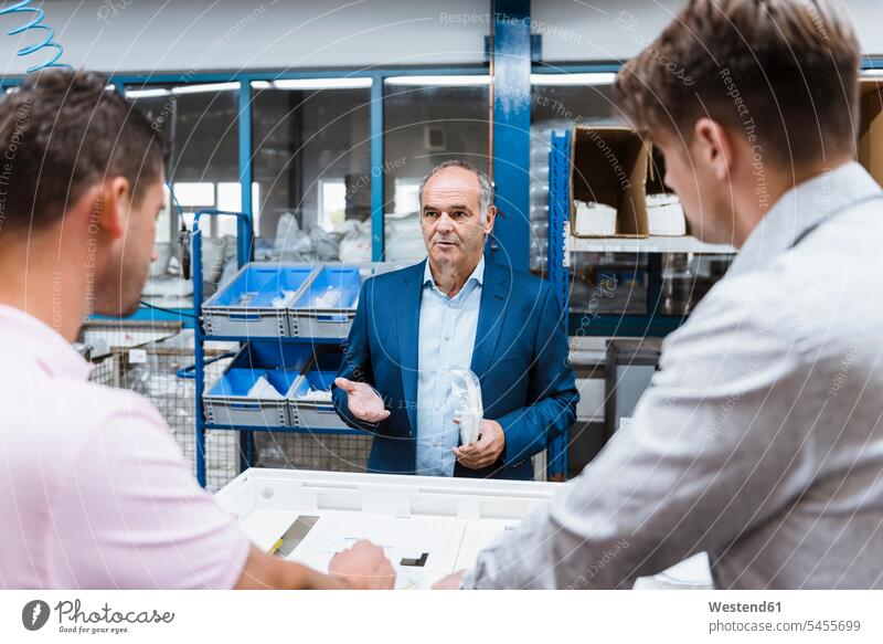 Business people standing on shop floor, discussing product improvement Business Meeting business conference meeting business people businesspeople Quality